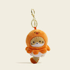 A plush orange cat bag charm inside a golden-brown Takoyaki-shaped costume with embroidered whiskers and pink paw details. It is attached to a gold lobster clasp and keyring, designed as a cute and trendy accessory for bags or keychains.
