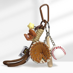 A close-up of a baseball-themed keychain with a brown carabiner clip, featuring a yellow star charm, a brown coffee cup charm, a detailed brown leather baseball glove, and a white baseball with red stitching, attached to a braided rope strap.