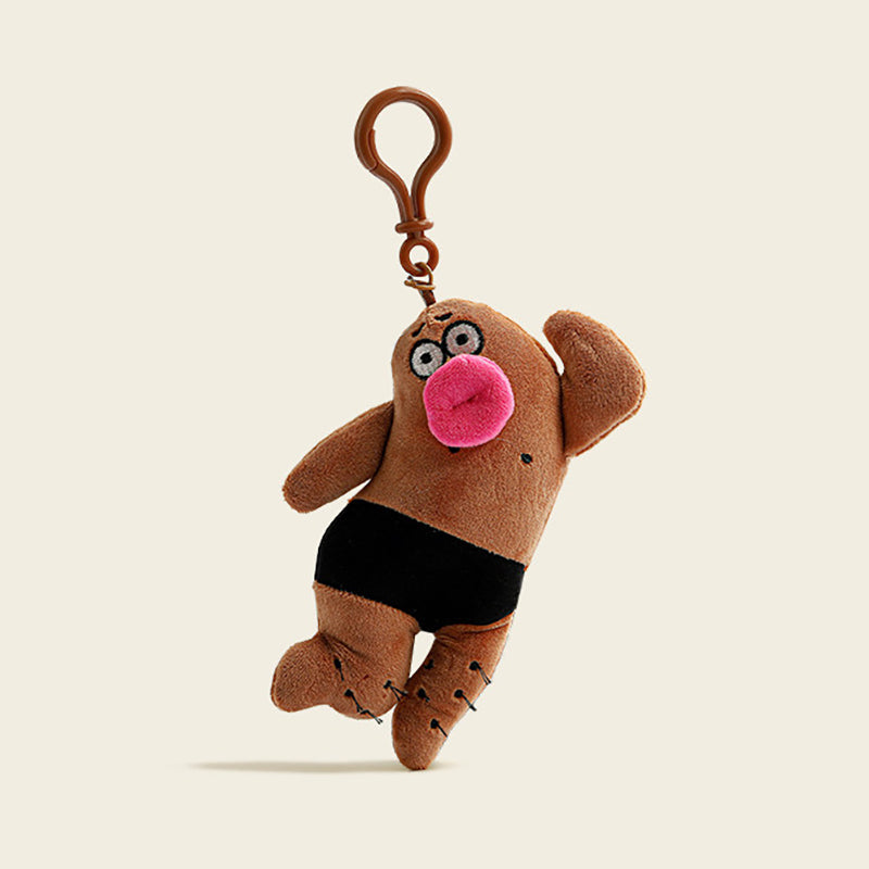 A plush gingerbread man bag charm in brown fabric with black pants, a pink mouth, and black dots on its body. It is attached to a brown carabiner clip, designed as a cute and quirky accessory for bags or keychains.