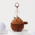 A side view of a brown plush cockroach keychain with embroidered details, black antennae, and a fuzzy body, attached to a gold-tone metal carabiner and keyring.