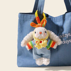 A white plush rabbit bag charm with long floppy ears, wearing a colorful striped sweater and blue overalls, topped with a crocheted orange hat, hanging from a blue canvas bag as a cute and trendy bag charm.
多巴胺垂
