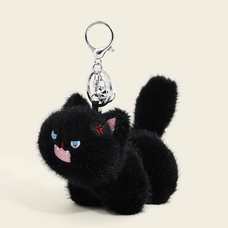 A fluffy black cat plush bag charm with bright blue eyes, a pink tongue sticking out, and a small red mark on its forehead. It is attached to a silver lobster clasp and keyring, designed as a cute and trendy accessory for bags or keychains.