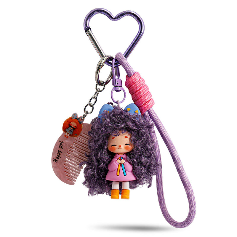 A purple heart-shaped metal clasp attached to a doll with deep purple curly hair and blue cat ears. The charm hangs from a lavender cord with a pink knot detail and includes a small comb accessory.