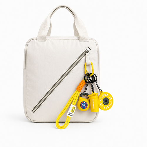 Yellow fitness bag charm set featuring a mini barbell plate, kettlebell, and shaker bottle. A unique gym gift for workout lovers.